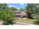 Backyard with a stone wall, patio and mature trees offering privacy at 4810 W 102Nd Pl, Westminster, CO 80031