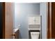 Cozy powder room with blue walls, toilet, and vanity with storage at 4810 W 102Nd Pl, Westminster, CO 80031