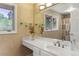 Spacious vanity with a large mirror, decorative elements, and double faucet sink at 4810 W 102Nd Pl, Westminster, CO 80031