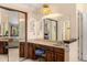 Bathroom featuring a vanity with a vintage chair, full mirror, vanity lighting, and a sink at 4810 W 102Nd Pl, Westminster, CO 80031
