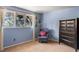 Bedroom featuring a large window, cozy chair, and large dresser with storage at 4810 W 102Nd Pl, Westminster, CO 80031