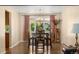 Elegant dining room with a chandelier, hardwood floors, and large window at 4810 W 102Nd Pl, Westminster, CO 80031