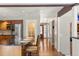Long hallway features hardwood floors, access to the kitchen, and a glass front door at 4810 W 102Nd Pl, Westminster, CO 80031