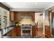 Modern kitchen features stainless steel appliances, wood cabinets, and granite countertops at 4810 W 102Nd Pl, Westminster, CO 80031