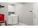 This laundry room features tile floor, white cabinets, and a washer and dryer at 4810 W 102Nd Pl, Westminster, CO 80031