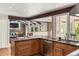 Open-concept living room with stone fireplace and views to the kitchen and backyard at 4810 W 102Nd Pl, Westminster, CO 80031
