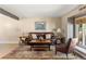 Comfortable living room featuring a plush leather sofa and ample natural light at 4810 W 102Nd Pl, Westminster, CO 80031