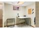 A small room with plaid wallpaper featuring a desk and a window at 4810 W 102Nd Pl, Westminster, CO 80031