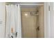 Neutral colored shower with modern shower head and white shower curtain at 4810 W 102Nd Pl, Westminster, CO 80031