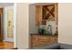 Wet bar area with wood cabinetry, sink, and wine rack at 4810 W 102Nd Pl, Westminster, CO 80031