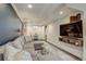 Inviting basement with a comfortable gray sectional, a glass coffee table, and a large screen TV at 2934 Chase St, Wheat Ridge, CO 80214