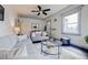 Inviting living room featuring comfortable sofas, a round glass coffee table, and a large window at 2934 Chase St, Wheat Ridge, CO 80214