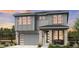 Two-story house with gray siding, stone accents, and a two-car garage at 7255 Prairie Sage Pl, Littleton, CO 80125