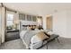 Main bedroom with a king-size bed and plenty of natural light at 7255 Prairie Sage Pl, Littleton, CO 80125