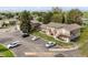 An aerial view of a multi-Gathering home surrounded by lush greenery, showcasing ample parking at 2271 Coronado N Pkwy # D, Denver, CO 80229