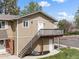 Charming end unit with a private deck and entrance, showcasing well-maintained landscaping and architecture at 2271 Coronado N Pkwy # D, Denver, CO 80229