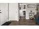 Hallway with hardwood flooring and a view of the adjacent, updated kitchen at 2271 Coronado N Pkwy # D, Denver, CO 80229