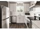 Updated kitchen featuring white cabinets, modern stainless steel appliances, and stylish countertops at 2271 Coronado N Pkwy # D, Denver, CO 80229