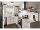 Modern kitchen featuring white cabinetry, subway tile backsplash, stainless steel appliances, and durable countertops at 2271 Coronado N Pkwy # D, Denver, CO 80229