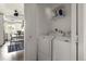Bright laundry room with white washer, dryer, and storage shelves conveniently located off the kitchen area at 2271 Coronado N Pkwy # D, Denver, CO 80229