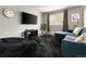 Cozy living room featuring a large window and comfortable seating arrangement at 2271 Coronado N Pkwy # D, Denver, CO 80229