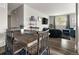 Open living space with dark floors and an adjoining dining area for seamless entertaining at 2271 Coronado N Pkwy # D, Denver, CO 80229