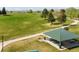 Aerial view of a park featuring a green gazebo with picnic tables, surrounded by lush trees and walking paths at 2271 Coronado N Pkwy # D, Denver, CO 80229