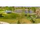Aerial view of a park featuring green spaces, a lake, a gazebo, and walking paths, perfect for outdoor activities at 2271 Coronado N Pkwy # D, Denver, CO 80229