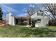 Expansive backyard with a covered patio, mature landscaping, and well-maintained lawn at 2725 S Monroe St, Denver, CO 80210