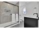 Modern bathroom featuring a glass shower, black hardware, stone floors, and contemporary fixtures at 2725 S Monroe St, Denver, CO 80210