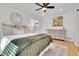 Cozy bedroom with a ceiling fan, neutral decor, and a large dresser at 2725 S Monroe St, Denver, CO 80210