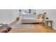 Well-lit bedroom features wood floors and a comfortable bed with stylish decor at 2725 S Monroe St, Denver, CO 80210