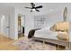Bright bedroom with a ceiling fan, hardwood floors, and a connected bathroom with modern design at 2725 S Monroe St, Denver, CO 80210