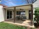 Cozy covered patio with seating, ceiling fan, and decorative columns; perfect for outdoor relaxing at 2725 S Monroe St, Denver, CO 80210