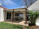 The covered patio is a perfect space with seating, a ceiling fan, and decorative pillars overlooking the lawn at 2725 S Monroe St, Denver, CO 80210