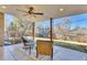 Covered patio has seating, a ceiling fan, and decorative pillars overlooking the lawn at 2725 S Monroe St, Denver, CO 80210
