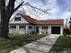 Charming one-story home with a red roof, a black garage door, and a well-manicured lawn at 2725 S Monroe St, Denver, CO 80210