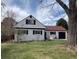 Charming home featuring a well-kept lawn, red roof, black shutters, and a one-car garage at 2725 S Monroe St, Denver, CO 80210