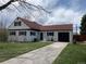 Charming home with well-maintained lawn, black trim, and a private driveway at 2725 S Monroe St, Denver, CO 80210