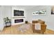 Bright living room with a modern fireplace, TV, and plush accent chair for relaxation at 2725 S Monroe St, Denver, CO 80210
