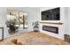 Bright living room featuring sleek floors, a modern fireplace, and sliding glass doors to the backyard at 2725 S Monroe St, Denver, CO 80210