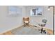 Bright office space features wood floors, large windows, and a modern desk with stylish chair and rug at 2725 S Monroe St, Denver, CO 80210