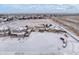 Aerial view of a residential area with houses and snow-covered fields at 1523 Honeysuckle Ct, Brighton, CO 80601