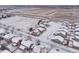 A winter aerial view of a residential area with snow-covered houses and landscape at 1523 Honeysuckle Ct, Brighton, CO 80601