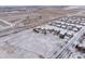 Aerial shot of cozy homes nestled in a community with a large empty field at 1523 Honeysuckle Ct, Brighton, CO 80601