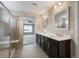 Bathroom featuring a walk-in shower and double vanity with bright lighting and neutral paint at 1523 Honeysuckle Ct, Brighton, CO 80601