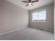 Bright bedroom with a ceiling fan and a large window providing ample natural light and neighborhood views at 1523 Honeysuckle Ct, Brighton, CO 80601