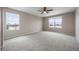 Spacious bedroom with two windows, providing ample natural light and scenic outdoor views at 1523 Honeysuckle Ct, Brighton, CO 80601