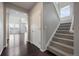 Entryway with hardwood floors, staircase, and open to the living room at 1523 Honeysuckle Ct, Brighton, CO 80601