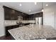 Gourmet kitchen with granite countertops, stainless steel appliances, and a large center island at 1523 Honeysuckle Ct, Brighton, CO 80601
